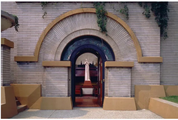 Exterior photograph of the front door to the Dana-Thomas house by Frank Lloyd Wright in Springfield, IL. Flower in the Crannied Wall statue can be seen in the doorway.